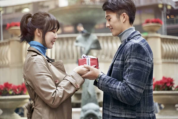 Young Asian Man Giving Girlfriend Christmas Birthday Gift — Stock Photo, Image