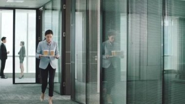 Genç Asyalı stajyer ya da sekreter konferans odasında yöneticilere kahve servisi yapıyor.