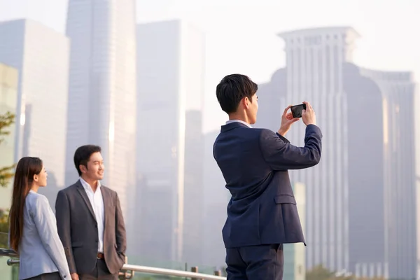 Mladý Asijský Podnikatel Pořízení Fotografie Města Pomocí Mobilního Telefonu — Stock fotografie