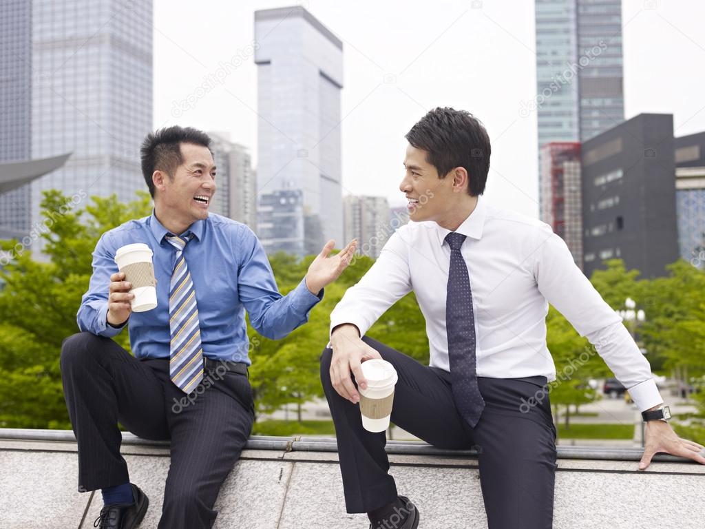 Asian Business People Talking Outdoors Stock Photo C Imtmphoto