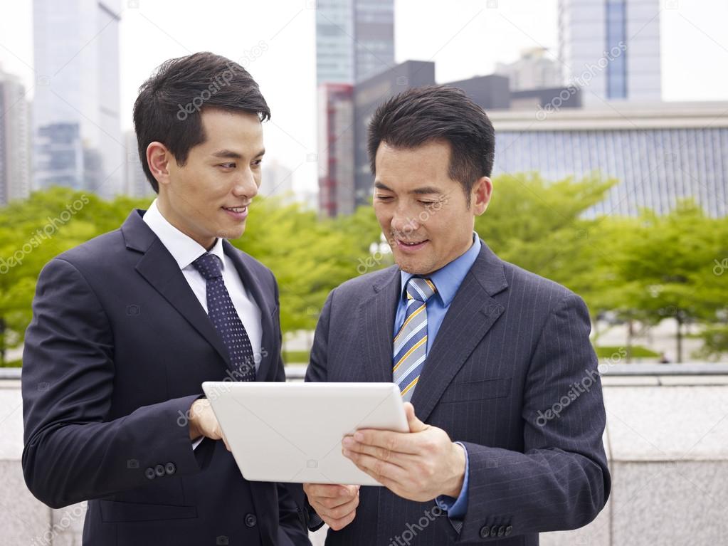 Asian businessmen using ipad Stock Photo by ©imtmphoto 52349307