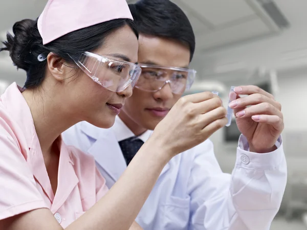 Asian medical professionals at work — Stock Photo, Image