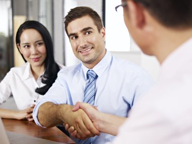 businesspeople shaking hands before meeting clipart