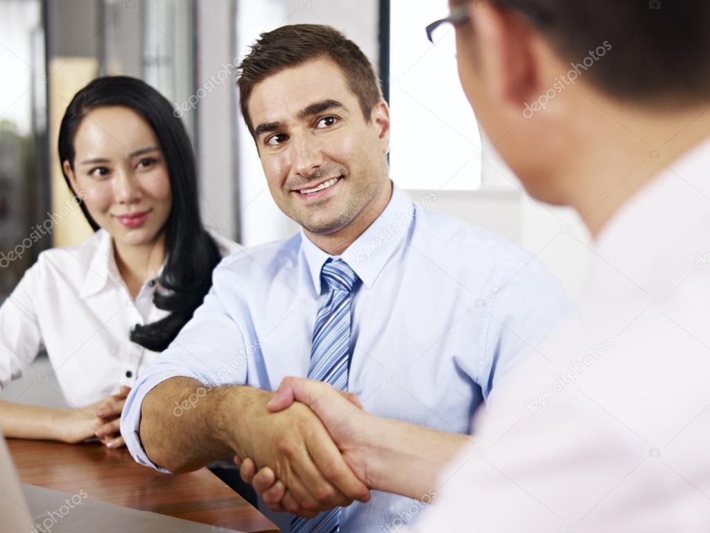 businesspeople shaking hands before meeting