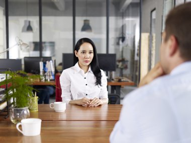 young asian business executive being interviewed clipart