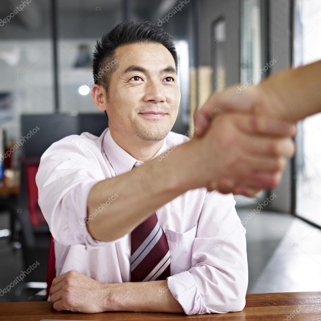 asian business person shaking hands