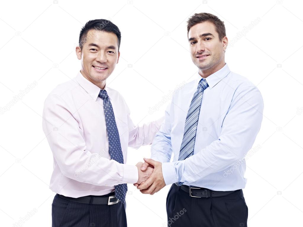 asian and caucasian businessmen shaking hands