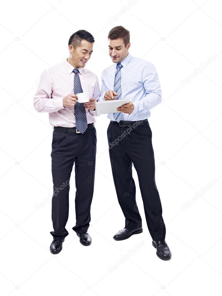 asian and caucasian businessmen having a  discussion