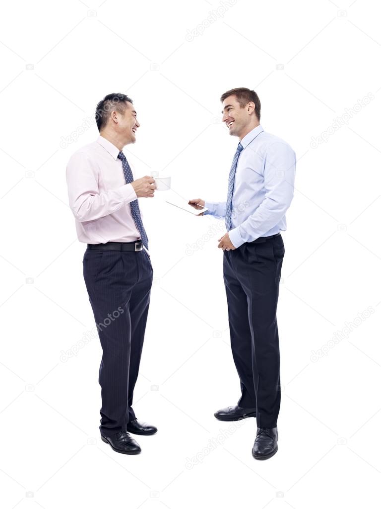 asian and caucasian businessmen having a  conversation