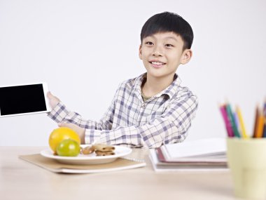 asian child showing his tablet clipart