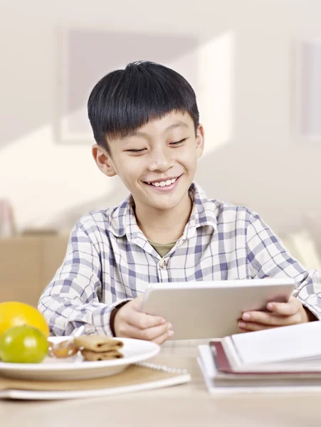 Азиатский ребенок с помощью планшетного компьютера — стоковое фото
