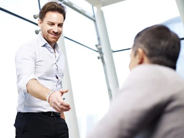 Businessman reaching out for a handshake — Stock Photo, Image