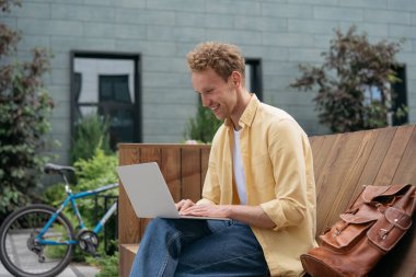 Klavyede dizüstü bilgisayar kullanan yakışıklı bir adam, çevrimiçi eğitim kursları izliyor. Başarılı bir metin yazarı sokaklarda serbest yazar olarak çalışıyor. Gülümseyen öğrenci eğitimi, eğitim konsepti