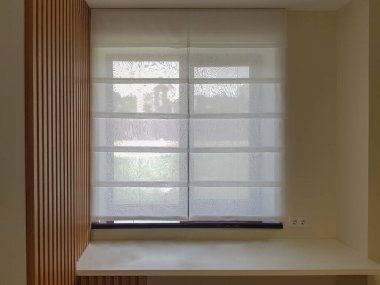 transparent roman blind on the window