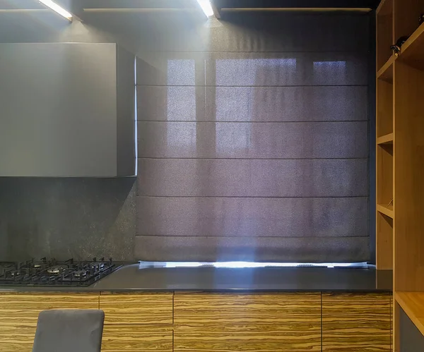 Roman blind in the interior of modern kitchen