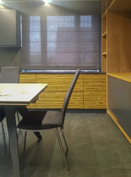 Roman blind in the interior of modern kitchen