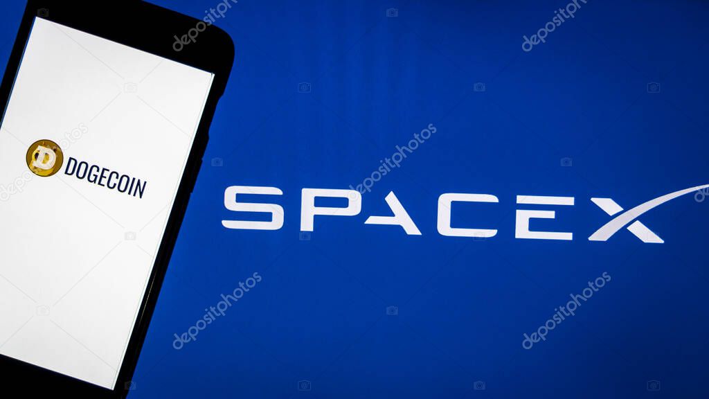Kathmandu, Nepal - May 11 2021: Dogecoin logo on a smartphone against SpaceX logo in the background. SpaceX accepts Dogecoin as payment to launch the DOGE-1 mission to the Moon next year.