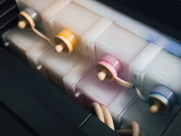 close-up of a printer's continuous ink supply system (ciss) tanks