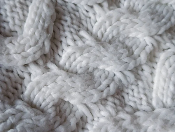 Sıcak kış arkaplanı için tıknaz beyaz kablo yün dokusunun tam çerçevesi