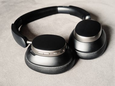 Gri arka plan teknolojisi aygıtında kulaklık üzerine kablosuz siyah