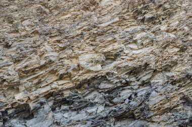 Pürüzsüz bir kayanın dış yüzeyiyle yüzünün tüm dokuları..