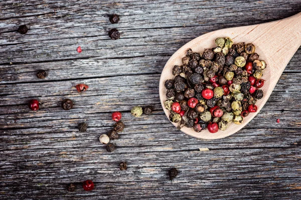 Mixture of peppers on spoon — Stock Photo, Image