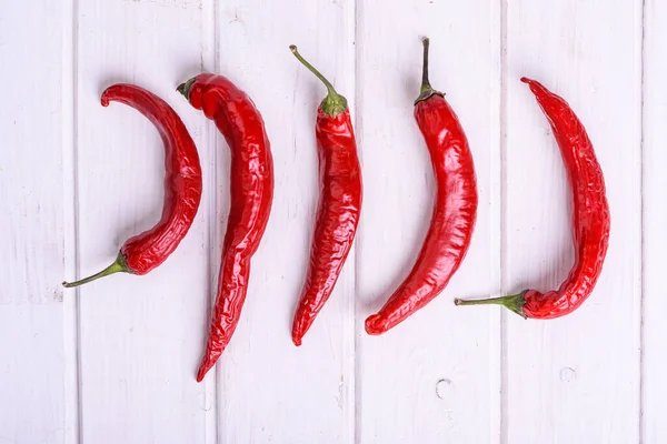 Red Hot Chili Peppers White Wood Table Top View — Stock Photo, Image