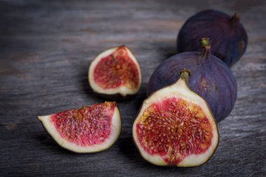 Tahta arka planda taze incir dilimleri.