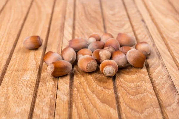 Whole hazelnuts on wooden background — Stock Photo, Image