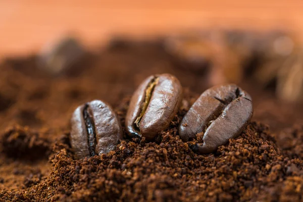 Closeup of  coffee beans with roasted coffee heap