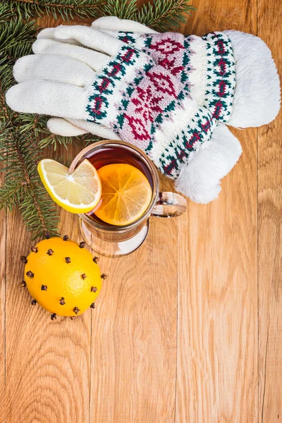 Mulled wine with spices and knitted gloves