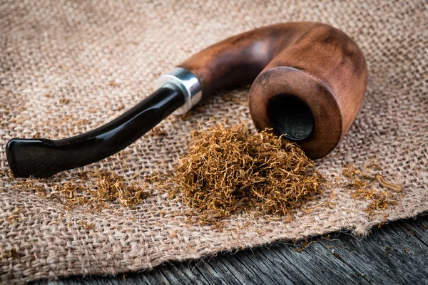 Smoking  pear pipe and tobacco on burlap