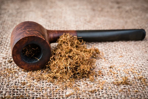 Smoking pipe on  burlap — Stock Photo, Image