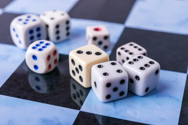 Dices on blue chess board — Stock Photo, Image