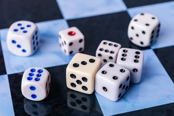 Dices on blue chess board — Stock Photo, Image