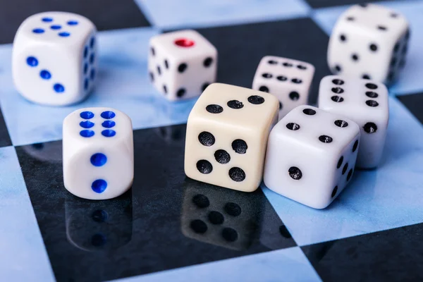 Dices on blue chess board — Stock Photo, Image