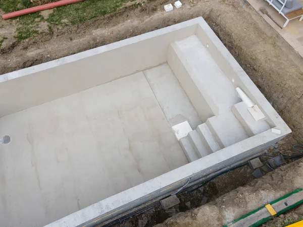 aerial drone shot of pool construction site almost finished spackling from above