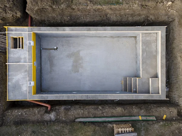 aerial drone photo of pool construction site in a garden