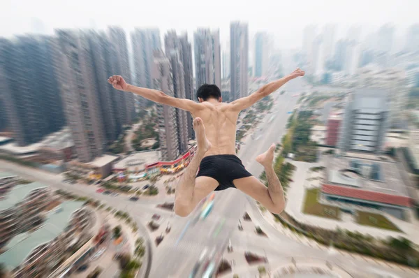 Man jumping with cityscape