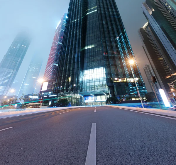 Asphalt road and modern city — Stock Photo, Image