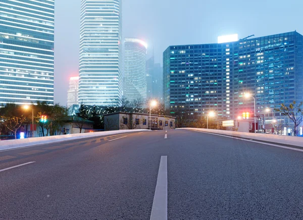 Asphalt road and modern city — Stock Photo, Image