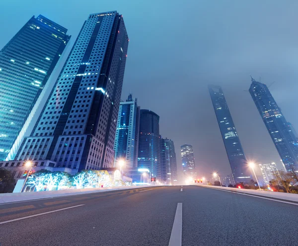 Asphalt road and modern city — Stock Photo, Image