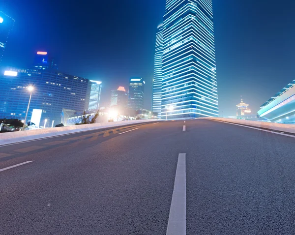 Asphalt road and modern city — Stock Photo, Image