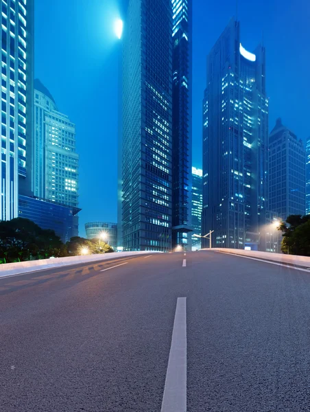 Asphalt road and modern city — Stock Photo, Image