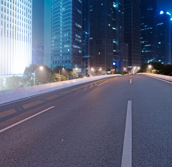 Asphalt road and modern city — Stock Photo, Image