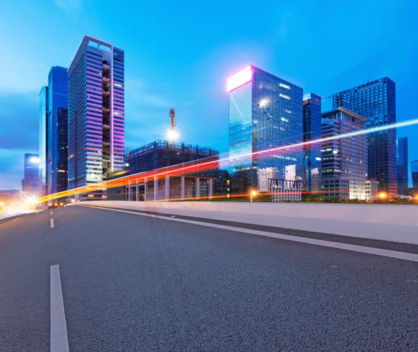 Asphalt road and modern city — Stock Photo, Image