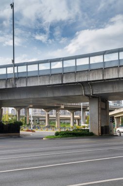 Şehirdeki üst geçidin altında beton yapı ve asfalt yol alanı