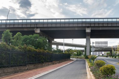 Şehirdeki üst geçidin altında beton yapı ve asfalt yol alanı