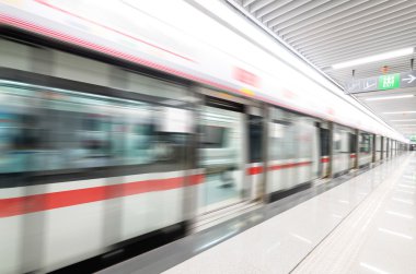 Tren metro istasyonunda hızla ilerliyor.