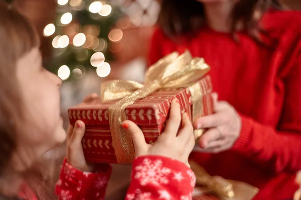 Little girl sends her mother a Christmas gift. Stock Image